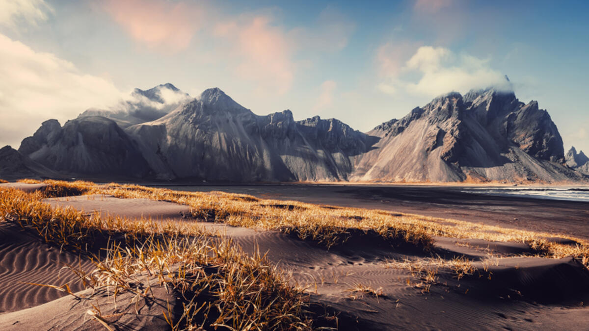 Vestrahorn mountaine on Stokksnes cape in Iceland during sunset. Amazing Iceland nature seascape. popular tourist attraction. Best famouse travel locations. Scenic Image of Iceland (Shutterstock)
