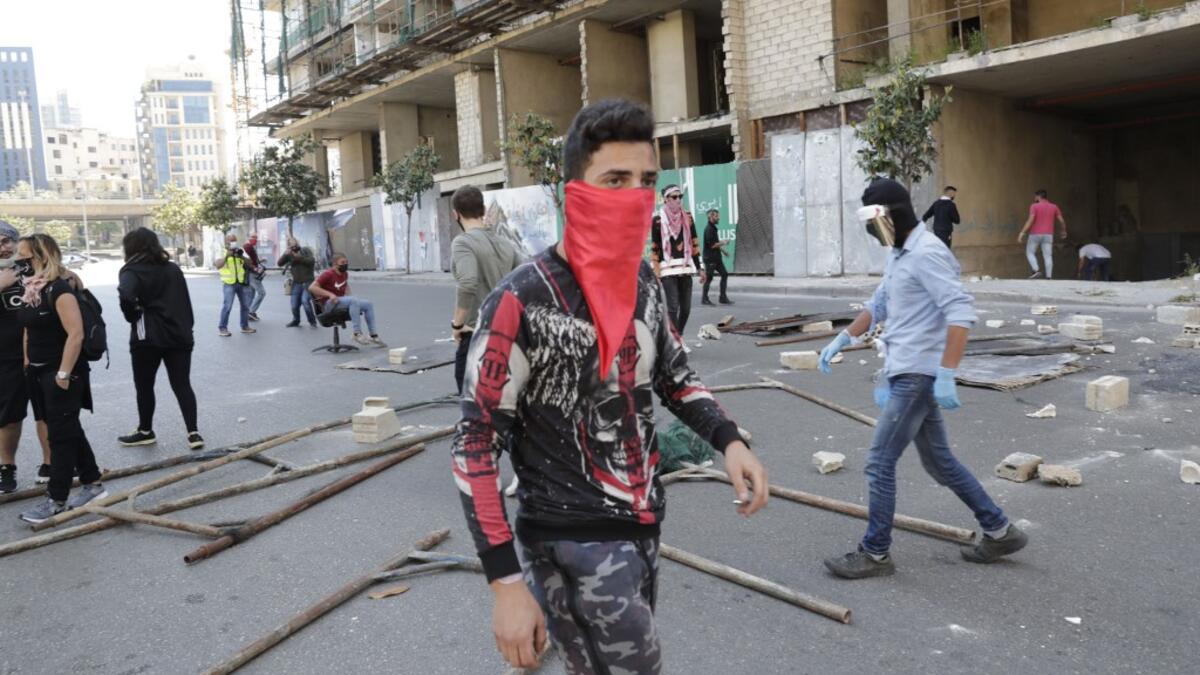 Lebanese anti-government protesters, some wearing protective masks amid the COVID-19 pandemic, block a road during a demonstration against the growing economic hardship in downtown Beirut on May 1, 2020, marking International Workers' Day (Labour Day). ANWAR AMRO / AFP
