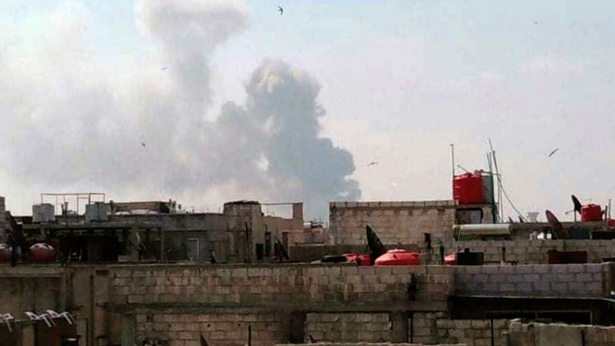 A handout picture released by the official Syrian Arab News Agency (SANA) on May 1, 2020, shows smoke billowing above buildings in Syria's central city of Homs. SANA said that the explosions ringing out of a Syrian army position in Homs resulted from a "human error during the transport of some ammunition, which led to human and material losses", while the Syrian Observatory for Human Rights, a Britain-based war monitor relying on sources inside Syria, said Israeli air strikes hit a missile depot belonging t