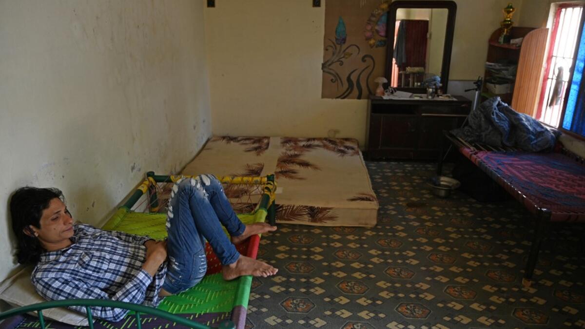 In this picture taken on May 8, 2020, member of the transgender community Adnan Ali (L) rests inside a shelter house in Bari Imam neighbourhood of Islamabad. Transgender people in the country are known as "khawajasiras" or "hijras" -- an umbrella term denoting a third sex that includes transgender women and cross-dressers. Pakistan became one of the first countries in the world to legally recognise a third sex in 2009 and began issuing transgender passports from 2017. Aamir QURESHI / AFP