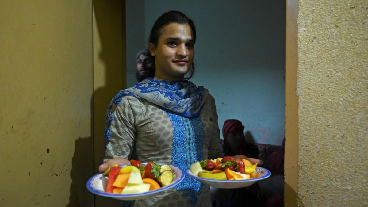 In this picture taken on May 9, 2020, a member of the transgender community carries food for "iftar" before breaking their fast during the Islamic holy month of Ramadan at the Guru transgender house in Rawalpindi. Transgender people in the country are known as "khawajasiras" or "hijras" -- an umbrella term denoting a third sex that includes transgender women and cross-dressers. Pakistan became one of the first countries in the world to legally recognise a third sex in 2009 and began issuing transgender pass