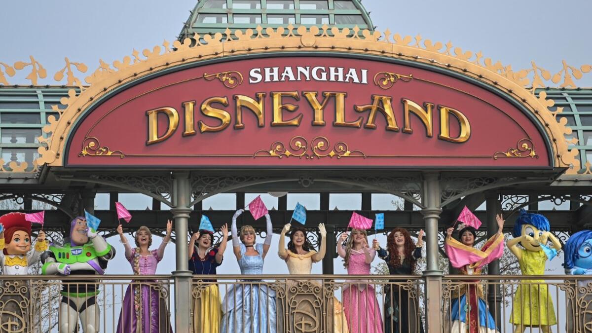 Performers dressed as Disney characters are seen during the reopening of the Disneyland amusement park in Shanghai on May 11, 2020. Disneyland Shanghai reopened on May 11 to the public after being closed since January due to the COVID-19 coronavirus outbreak. Hector RETAMAL / AFP