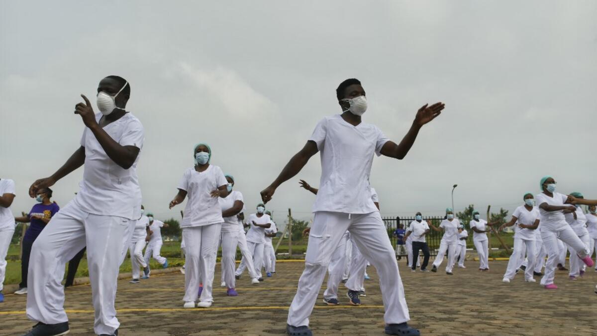 Nurses assigned to the Infectious Diseases Unit (IDU) at the Kenyatta University Hospital dance during a Zumba class held at the hospital compound in Nairobi, on May 17, 2020. Coinciding with the morning shift rotation the class, aimed to offer some respite to nurses charged with the management of patients infected with COVID-19 coronavirus, was organised by the Nursing Council of Kenya (NCK) and the Kenyatta Univesity Teaching, Refferal and Research Hospital in the Kenyan capital. TONY KARUMBA / AFP