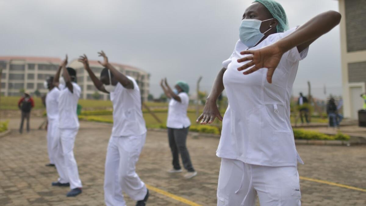 Nurses assigned to the Infectious Diseases Unit (IDU) at the Kenyatta University Hospital dance during a Zumba class held at the hospital compound in Nairobi, on May 17, 2020. Coinciding with the morning shift rotation the class, aimed to offer some respite to nurses charged with the management of patients infected with COVID-19 coronavirus, was organised by the Nursing Council of Kenya (NCK) and the Kenyatta Univesity Teaching, Refferal and Research Hospital in the Kenyan capital. TONY KARUMBA / AFP