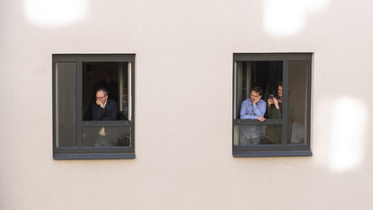 Guests of Zeitgeist Hotel listen from their rooms to singers Monika Medek and Dagmar Dekanovsky and the Camerata Carnutum orchestra, during a window concert (Fensterkonzert) in Vienna on May 30, 2020, as hotels have reopened in Austria amid the novel coronavirus pandemic. JOE KLAMAR / AFP