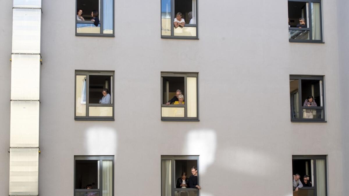 Guests of Zeitgeist Hotel listen from their rooms to singers Monika Medek and Dagmar Dekanovsky and the Camerata Carnutum orchestra, during a window concert (Fensterkonzert) in Vienna on May 30, 2020, as hotels have reopened in Austria amid the novel coronavirus pandemic. JOE KLAMAR / AFP