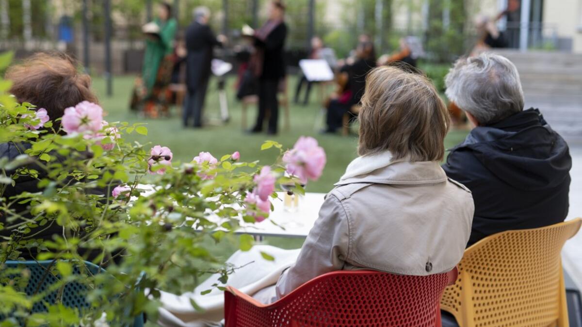 Guests of Zeitgeist Hotel listen to singers Monika Medek and Dagmar Dekanovsky and the Camerata Carnutum orchestra, during a window concert (Fensterkonzert) in Vienna on May 30, 2020, as hotels have reopened in Austria amid the novel coronavirus pandemic. JOE KLAMAR / AFP