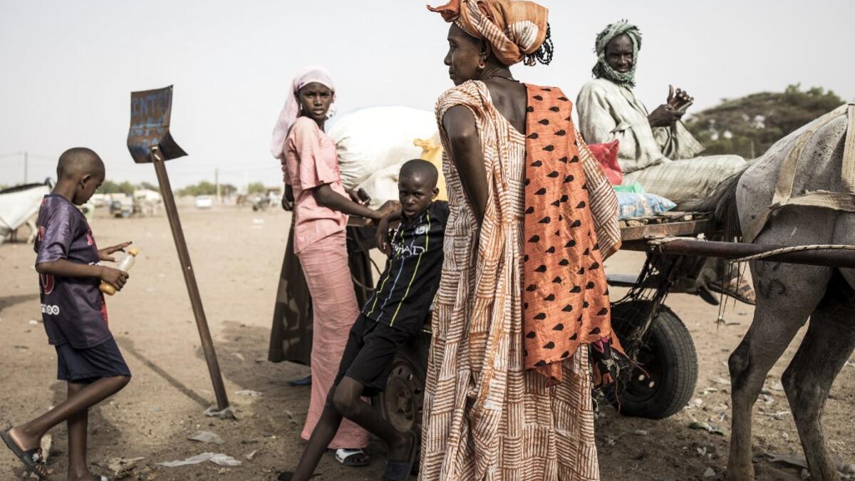 A family of Fulani herders pack their cart before making their way back to their camps after trying to buy and sell goods at a unofficial herders market in Barkedji on May 28, 2020. COVID-19 coronavirus restrictions have closed down markets and regional movement, as a result Fulani herders are struggling to move to areas with more grazing land for there live stock. Closures of markets have meant that the prices for live stock has dropped by up to fifty percent, leaving the pastoralist stuck with out being a