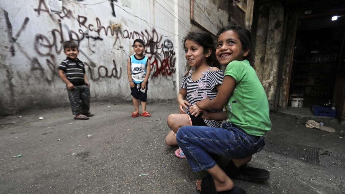 A boy looks out from a balconey along an alley in the Bab al-Tabbaneh neighbourhood of Lebanon's northern city of Tripoli on June 3, 2020. Thousands of residents of Lebanon's northern Tripoli struggle to put food on the table, as the country's worst economic crisis in decades has picked up in speed in recent weeks, with food prices rising by more than 70 percent since the autumn. Inflation has been a blow in the country where more than 45 percent of the country's population now lives below the poverty line,
