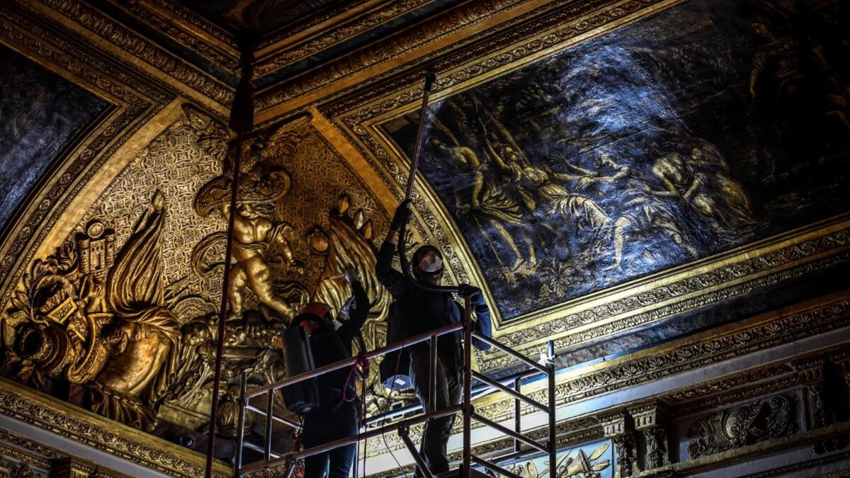 An employee wearing a protective face mask cleans the Queen's grand appartment at the Chateau de Versailles (Palace of Versailles) in Versailles near Paris, on June 5, 2020 on the eve of it re-opening after 82 days of closure due to the novel coronavirus (COVID-19) outbreak. The Palace of Versailles -- France's big tourist attraction with nearly 10 million tourists a year - will open on June 6 with no US or Asia tourists who represent 30% of its visitors. STEPHANE DE SAKUTIN / AFP