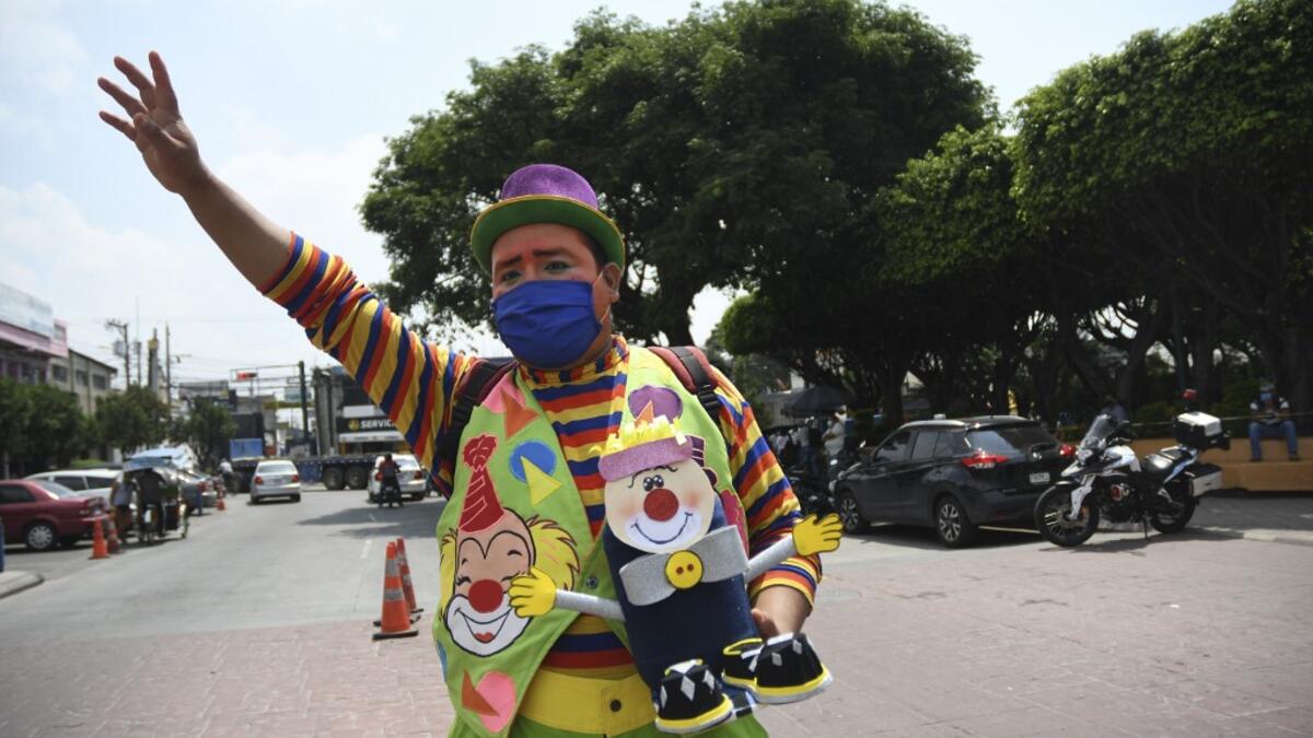 A clown begs for money to survive the crisis caused by the new coronavirus in Villa Nueva, 20 km south Guatemala City, on June 10, 2020, as clowns have been unable to work due to restrictions to prevent the spread of the COVID-19. Johan ORDONEZ / AFP