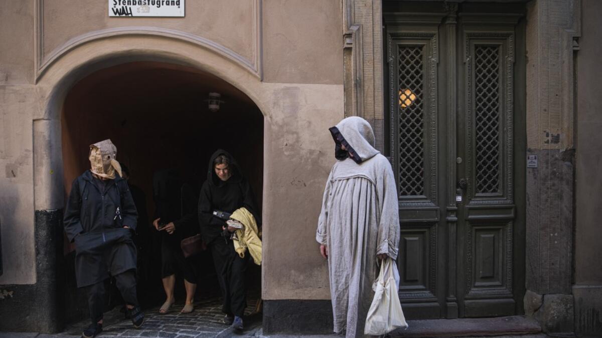 Tour guide Mike Anderson takes visitors on May 30 ,2020 on a 'plague walk', taking them around sites in Stockholm's old town related to pandemics of the plague in the 14th and 18th century, and an outbreak of cholera that hit the city in the mid-19th century. Jonathan NACKSTRAND / AFP