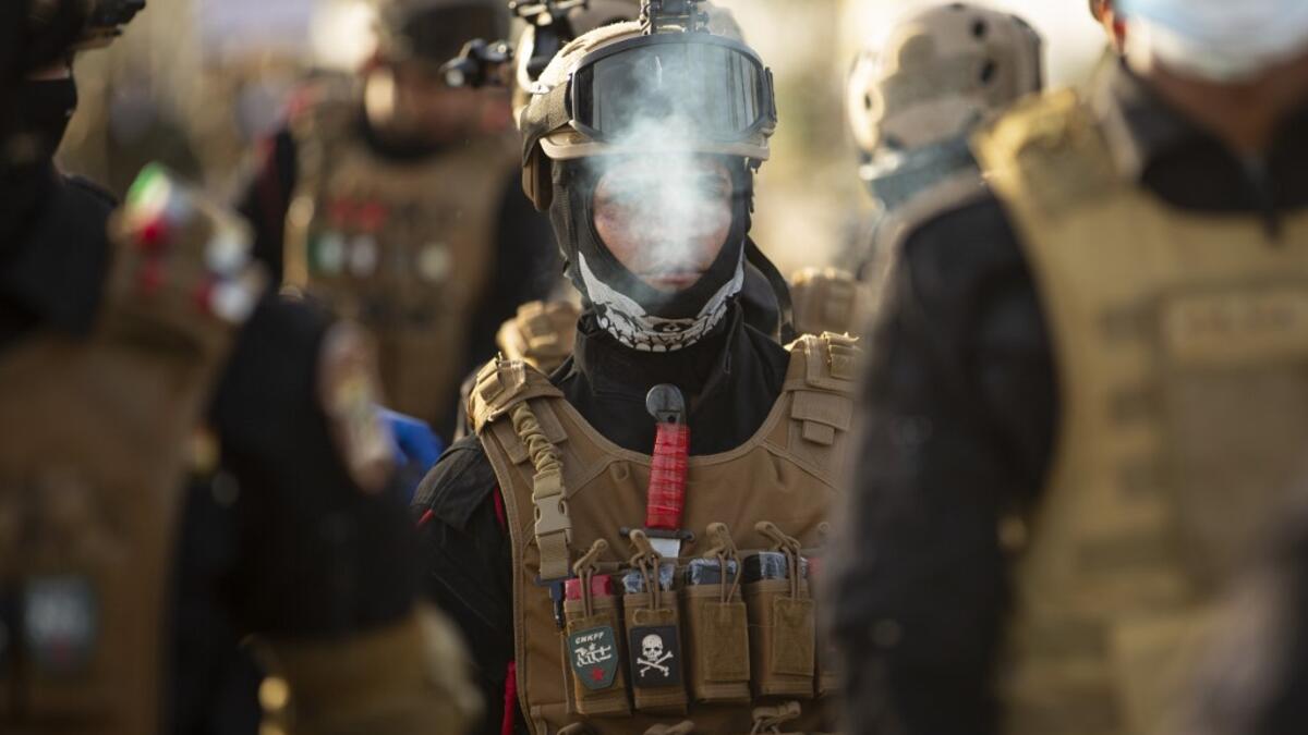 Members of the Hashed al-Shaabi (Popular Mobilisation) paramilitary force take part in a military parade in the southern Iraqi city of Basra on June 14, 2020, marking the sixth anniversary of its founding after Iraq's top Shiite cleric Grand Ayatollah Ali Sistani called to defend the country from the Islamic State group (IS). Hussein FALEH / AFP