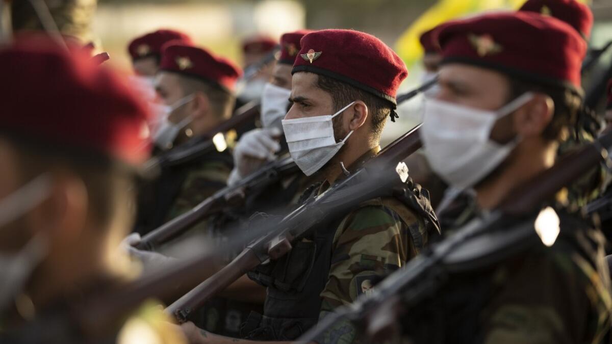 Members of the Hashed al-Shaabi (Popular Mobilisation) paramilitary force take part in a military parade in the southern Iraqi city of Basra on June 14, 2020, marking the sixth anniversary of its founding after Iraq's top Shiite cleric Grand Ayatollah Ali Sistani called to defend the country from the Islamic State group (IS). Hussein FALEH / AFP