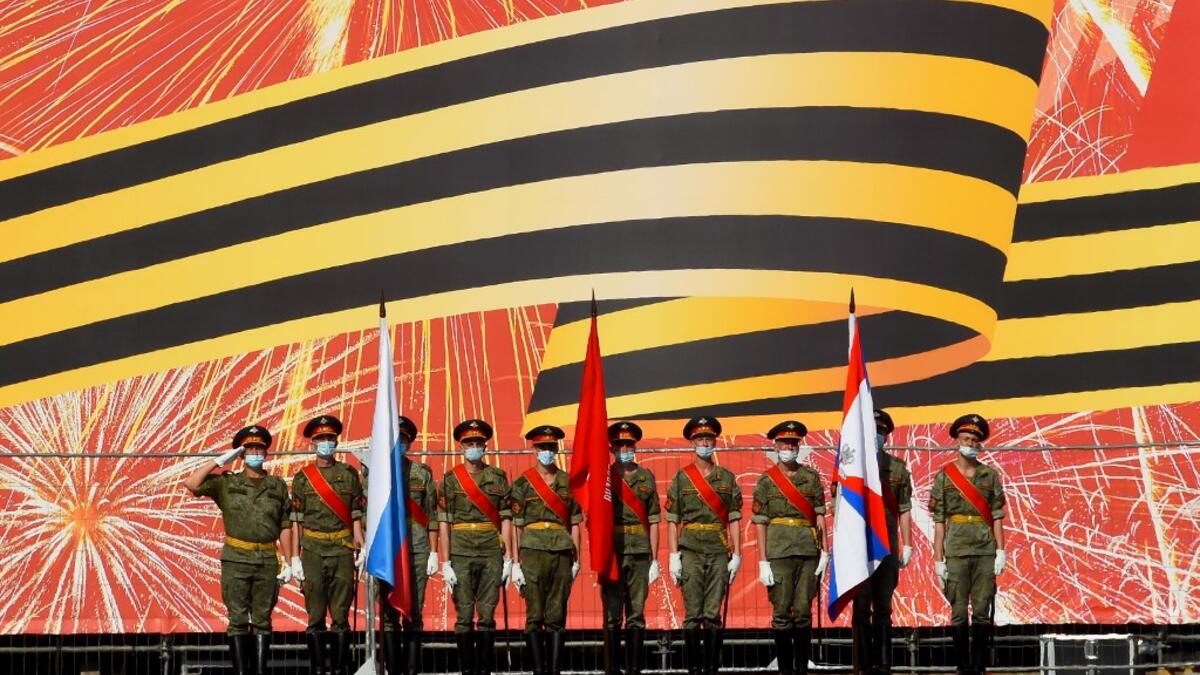 Russian servicemen wearing face masks and gloves take part in a rehearsal for June 24 military parade marking Soviet victory in World War II, which was postponed due to the coronavirus pandemic, at Dvortsovaya Square in Saint Petersburg on June 18, 2020. OLGA MALTSEVA / AFP