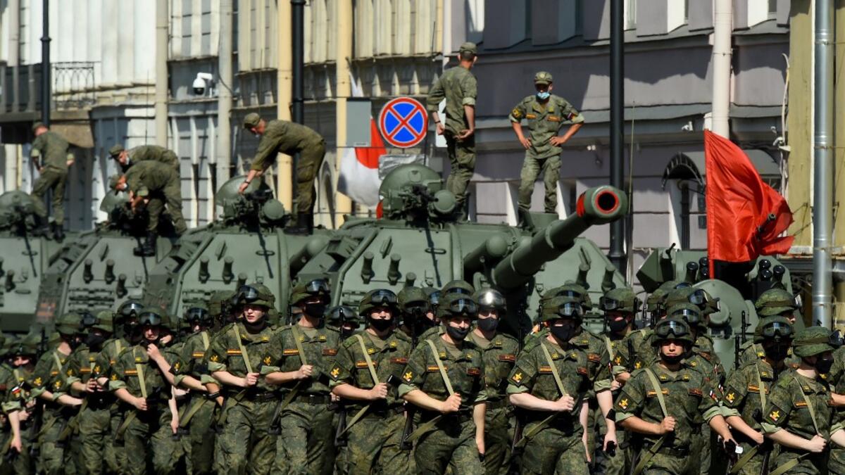 Russian servicemen wearing face masks take part in a rehearsal for June 24 military parade marking Soviet victory in World War II, which was postponed due to the coronavirus pandemic, at Dvortsovaya Square in Saint Petersburg on June 18, 2020. OLGA MALTSEVA / AFP