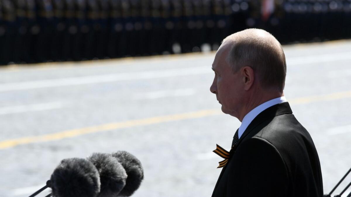 Russian President Vladimir Putin and guests observe a minute of silence during a military parade, which marks the 75th anniversary of the Soviet victory over Nazi Germany in World War Two, at Red Square in Moscow on June 24, 2020. The parade, usually held on May 9, was postponed this year because of the coronavirus pandemic. Alexey NIKOLSKY / SPUTNIK / AFP