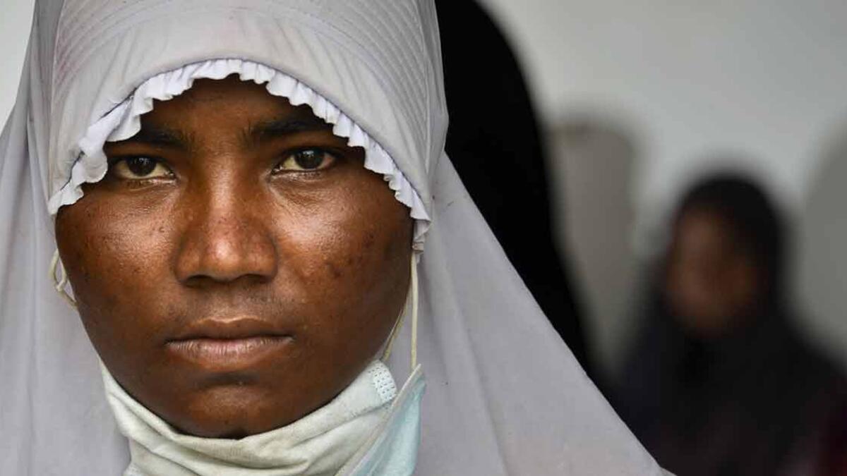 A Rohingya from Myanmar gets her identification photograph taken by Indonesian police at the immigration detention centre in Lhokseumawe, in Indonesia's North Aceh Regency. (AFP Photo)