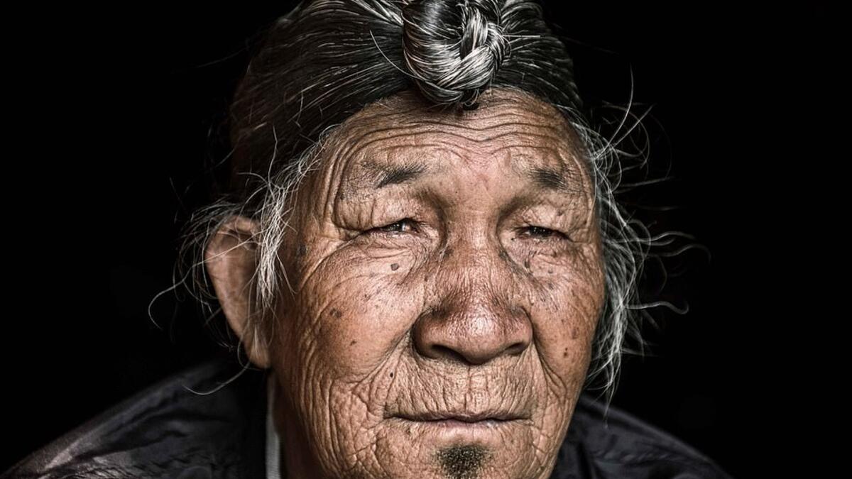 The travel photographer travelled deep into the heart of mountainous Nagaland, India, to capture the striking images. The man above wears a jacket as his long, grey hair is pulled into a bun sitting at the top of his head. (Mediadrumimages/ Trevor Cole)