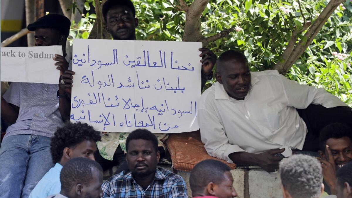 Sudanese workers, who lost their jobs due to the deteriorating economic situation in Lebanon, protest outside their county's embassy in Beirut to demand repatriation, on July 2, 2020. JOSEPH EID / AFP