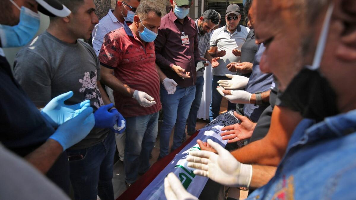 Mourners pray over the coffin of slain Iraqi jihadism expert Hisham al-Hashemi, who was shot dead yesterday outside his house in the Iraqi capital, during his funeral in Baghdad’s Zayouna district on July 7, 2020. Hashemi was an authoritative voice on Sunni jihadist factions including the Islamic State group, but was also frequently consulted by media and foreign governments on domestic Iraqi politics and Shiite armed groups. He had warm ties with top decision-makers, including President Barham Saleh.