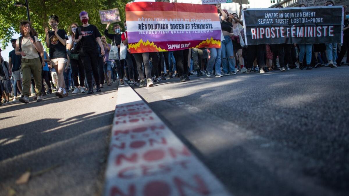 Protesters hold signs and banners as they take part in a demonstration called by feminist movements in Nantes, western France, on July 10, 2020, to denounce the nomination of French Interior Minister, facing rape accusations and French Justice Minister who criticised the #MeToo movement against sexual harassment. LOIC VENANCE / AFP