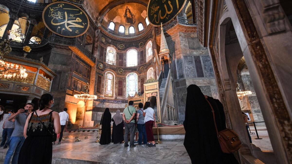 Tourists visit the inside of Hagia Sophia on July 10, 2020, in Istanbul, before a top Turkish court revoked the sixth-century Hagia Sophia's status as a museum, clearing the way for it to be turned back into a mosque. The Council of State, the country's highest administrative court which on July 2 debated a case brought by a Turkish NGO, cancelled a 1934 cabinet decision and ruled the UNESCO World Heritage site would be reopened to Muslim worshipping. The sixth-century Istanbul building -- a magnet for tour