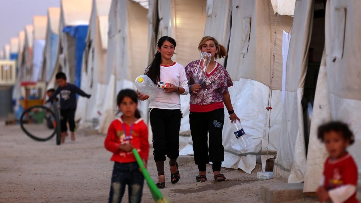 Displaced Iraqis from the Yazidi community, who fled violence between Islamic State (IS) group jihadists and Peshmerga fighters in the northern Iraqi town of Sinjar, are seen at a camp for internally displaced persons (IDP) in the Sharya area some 15 kilometres from the northern Iraqi city of Dohuk on May 20, 2015. (AFP / Safin Hamed)