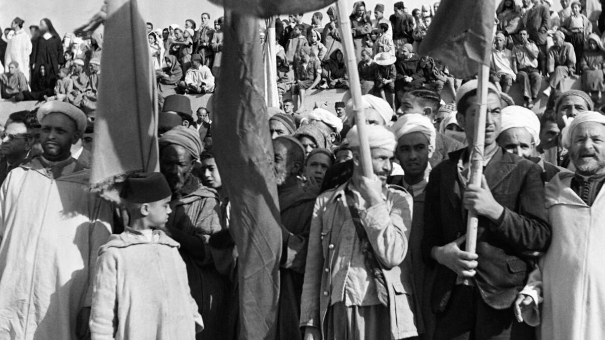 People hold Moroccan flags during a ceremony on the Grand Socco place, in October 1945 in Tangiers, Morocco. AFP