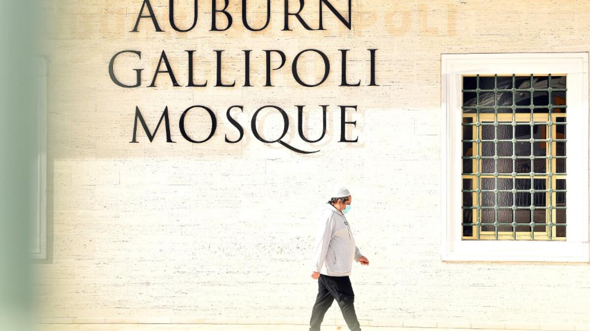 A Muslim worshipper leaves Auburn Gallipoli Mosque after mass Friday prayer on the first day of the Eid al-Adha festival in Sydney on July 31, 2020. Muslims in Australia offered their Eid Al-Adha and Friday prayers inside the mosques with limitations and restrictions to halt the spread of the COVID-19 coronavirus as the country recorded over 16,000 coronavirus cases and 189 deaths in a population of 25 million. SAEED KHAN / AFP