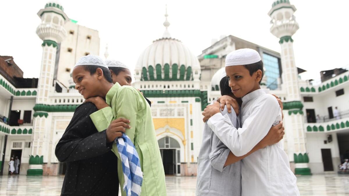 Muslim devotees greet each other after offering a special morning prayer on the occasion of Eid al-Adha, the feast of sacrifice, at the Jama Masjid Khairuddin in Amritsar on August 1, 2020. NARINDER NANU / AFP