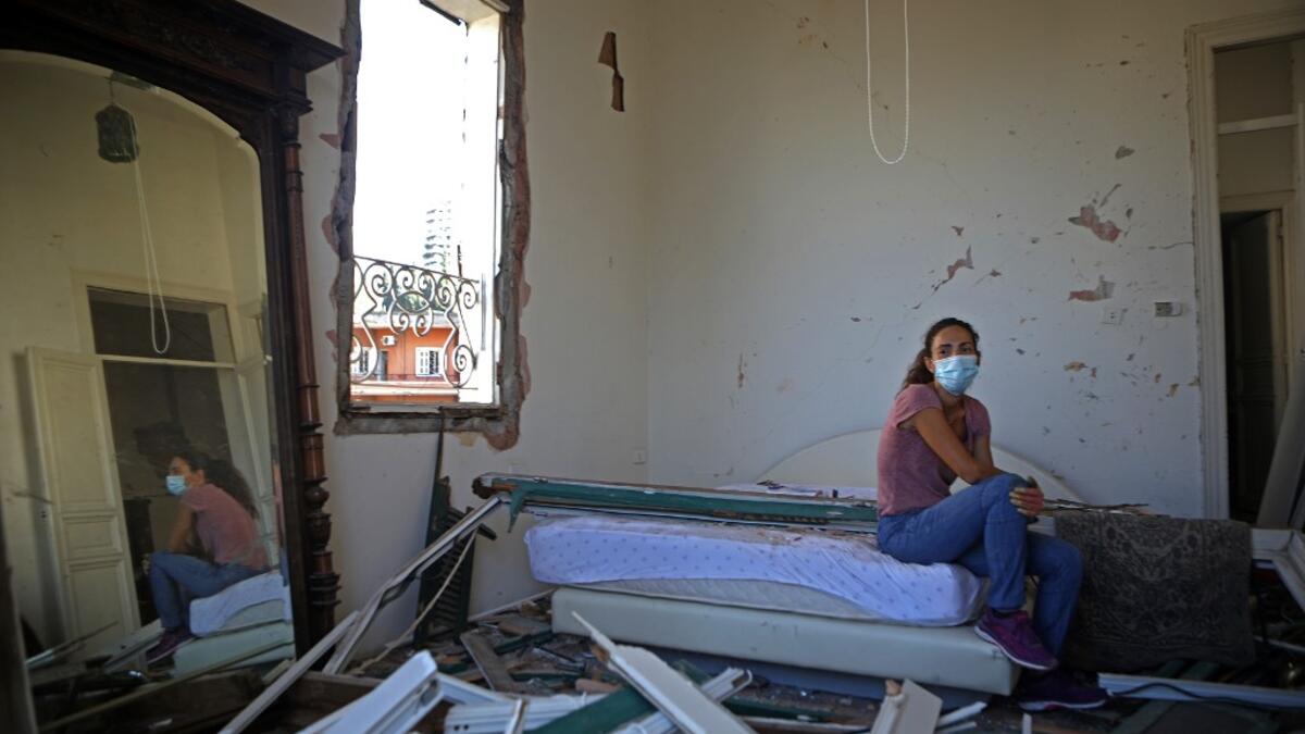 Lebanese dietitian Lama Mattar sits in her damaged bedroom in the damaged neighbourhood of Mar Mikhael in the Lebanese capital Beirut on August 6, 2020, two days after a massive explosion shook the Lebanese capital. The blast, which appeared to have been caused by a fire igniting 2,750 tonnes of ammonium nitrate left unsecured in a warehouse, was felt as far away as Cyprus, some 150 miles (240 kilometres) to the northwest. The scale of the destruction was such that the Lebanese capital resembled the scene o