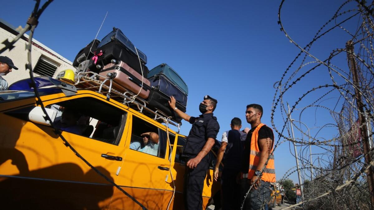 Palestinians prepare to leave Rafah border crossing with Egypt after months of closure due to the coronavirus pandemic in the southern Gaza Strip, on August 11, 2020 . SAID KHATIB / AFP