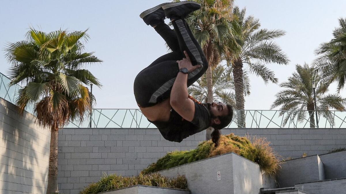 Hamzar Mekkaoui, 26, performs parkour, a sport that originated in France in the 1990s, which involves getting around urban obstacles with a fast-paced mix of jumping, vaulting, running and rolling, in the Qatari capital Doha, on August 11, 2020. Parkour, also known as free-running, has now found a small but committed following in Qatar despite evening temperatures that hover around 40 degrees Celsius (104 Fahrenheit) in summer and over-zealous security guards unfamiliar with the sport. KARIM JAAFAR / AFP
