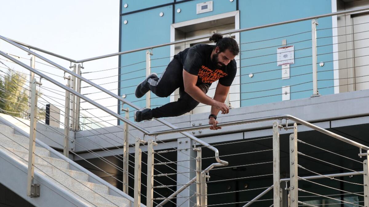 Hamzar Mekkaoui, 26, performs parkour, a sport that originated in France in the 1990s, which involves getting around urban obstacles with a fast-paced mix of jumping, vaulting, running and rolling, in the Qatari capital Doha, on August 11, 2020. Parkour, also known as free-running, has now found a small but committed following in Qatar despite evening temperatures that hover around 40 degrees Celsius (104 Fahrenheit) in summer and over-zealous security guards unfamiliar with the sport. KARIM JAAFAR / AFP