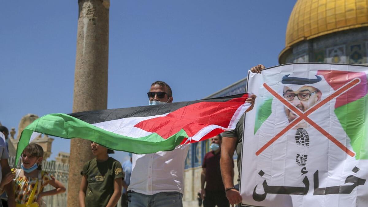 Palestinian protesters prepare to tear apart a portrait of Abu Dhabi Crown Prince Sheikh Mohammed bin Zayed al-Nahyan on August 14, 2020 at the al-Aqsa mosque compound in Jerusalem, during a protest against a US-brokered deal between Israel and the UAE to normalise relations. AFP