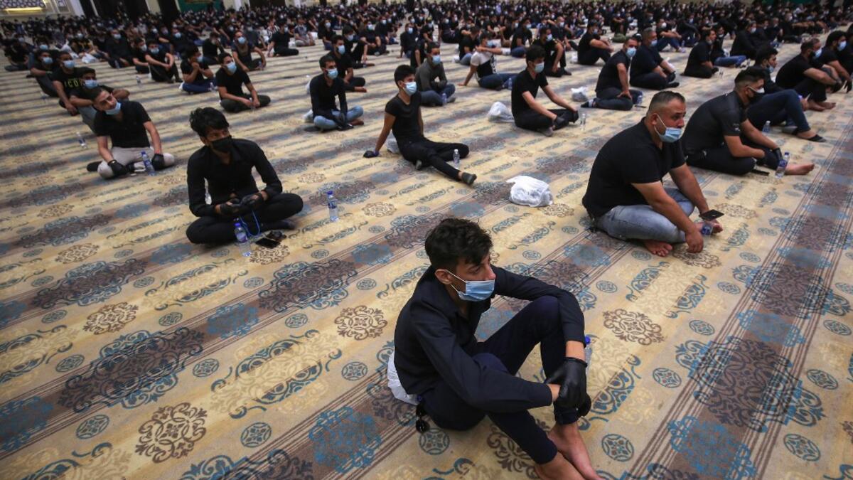 Iraqi Shiite Muslim men attend Ashura commemorations at the headquarters of Shiite Muslim leader and head of Hikma party Ammar al-Hakim, in the capital Baghdad, on August 21, 2020. Ashura is a period of mourning in remembrance of the seventh-century martyrdom of Prophet Mohammad's grandson Imam Hussein, who was killed in the battle of Karbala in modern-day Iraq, in 680 AD. AHMAD AL-RUBAYE / AFP