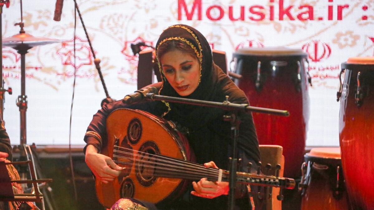 Noushin Yousefzadeh, oud player of the Iranian all-women music band "Dingo" performs with other band members at a concert during the state-organised "Persian Gulf music" festival at Avini Hall in Iran's southern Gulf port city of Bandar Abbas on April 29, 2019. ATTA KENARE / AFP