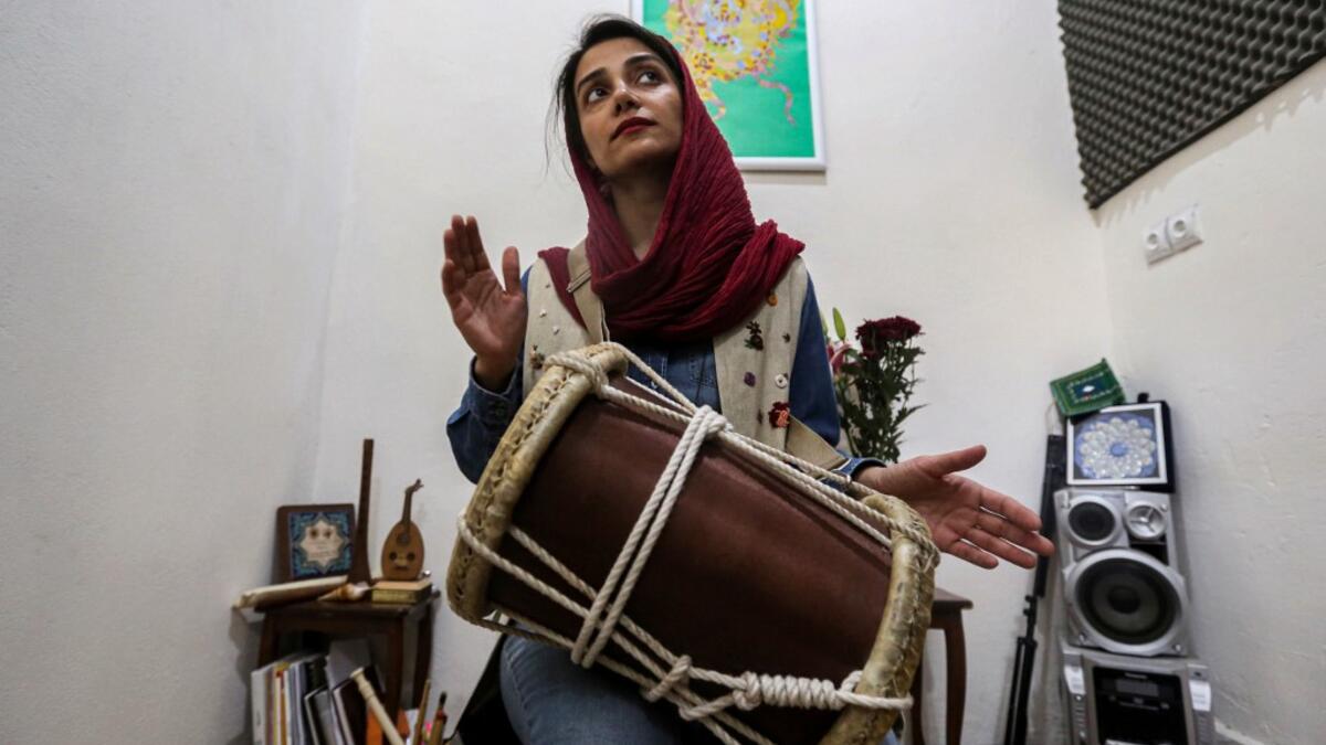 Negin Heydari, a former member of the all-women Iranian music band "Dingo" who plays the kasser drum, poses for a picture as she practises at a home studio called the "Dingo room" in Iran's southern Gulf port city of Bandar Abbas on April 30, 2019. ATTA KENARE / AFP