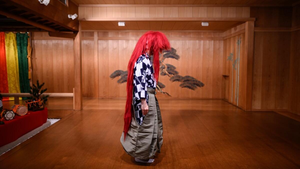 This photo taken on July 29, 2020 shows performer Kennosuke Nakamori posing with a red wig, or "akagashira", after an interview with AFP at the Kamakura Noh Theatre in the town of Kamakura in Kanagawa Prefecture, about one hour southwest of Tokyo. Philip FONG / AFP