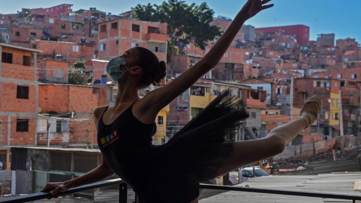 Mariana Sousa, student of the Ballet Paraisopolis, warms up during a rehearse in Paraisopolis favela, outskirts of Sao Paulo, Brazil on August 27, 2020, amid the new coronavirus COVID-19 pandemic. NELSON ALMEIDA / AFP