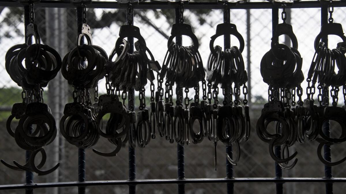Handcuffs hang from a railing during a search operation at the maximum security prison in Izalco, Sonsonate, El Salvador, on September 4, 2020. Authorities from the General Directorate of Penal Centres (DGCP) visited three Salvadorean prisons, some of maximum security, to check the situation of inmates and carry out searches amid the COVID-19 novel coronavirus pandemic. Yuri CORTEZ / AFP