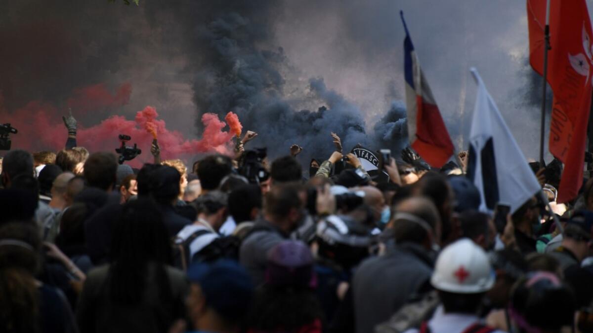 Protesters light flares during a demonstration called by the "yellow vest" (gilets jaunes) movement on September 12, 2020 in Paris. Alain JOCARD / AFP
