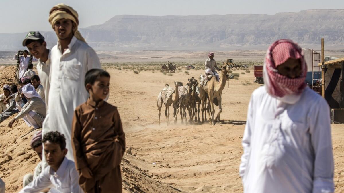 Bedouins watch a camel race in Egypt's South Sinai desert on September 12, 2020, after more than six month of hiatus due to the coronavirus outbreak. KHALED DESOUKI / AFP