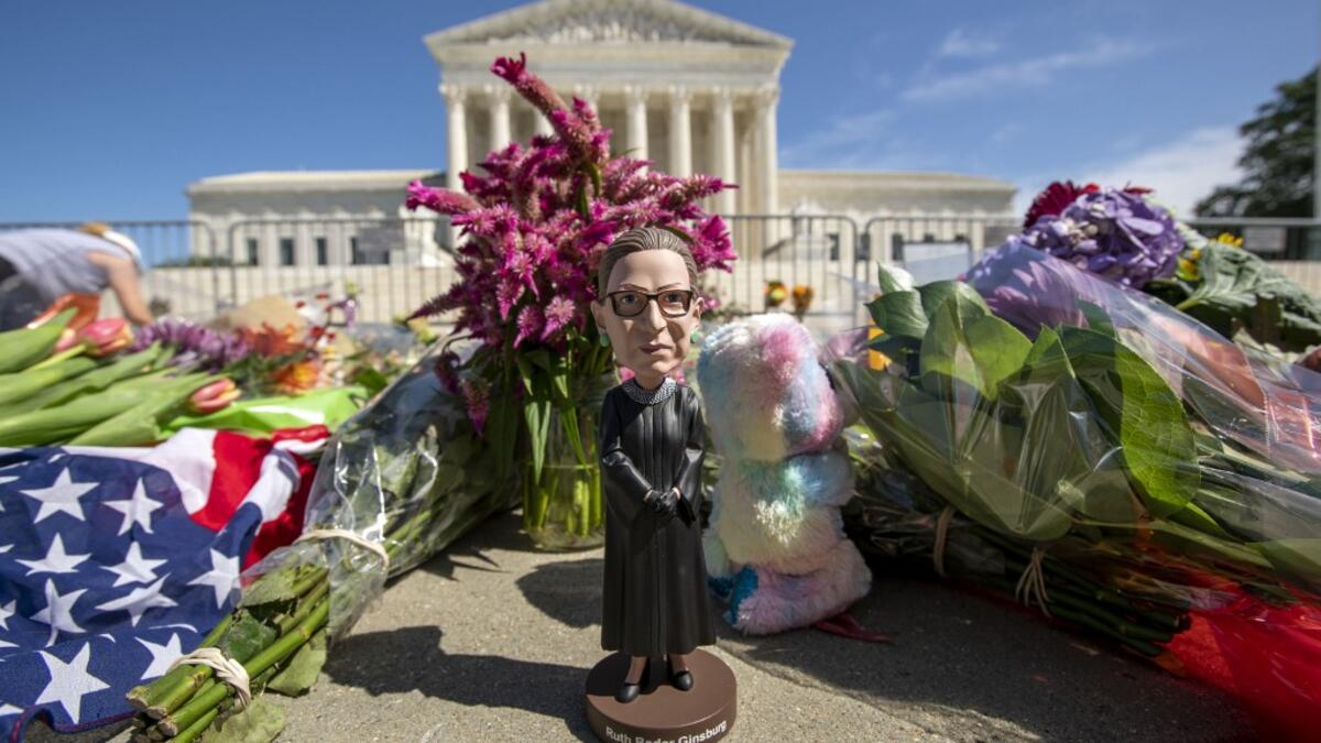 A bobblehead of US Supreme Court Justice Ruth Bader Ginsburg is left outside of the US Supreme Court in Washington, DC, on September 19, 2020. Ginsburg died September 18, opening a crucial vacancy on the high court expected to set off a pitched political battle at the peak of the presidential campaign. Jose Luis Magana / AFP