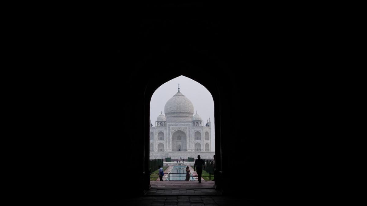 Tourists visit the Taj Mahal in Agra on September 21, 2020. The Taj Mahal reopened to visitors on September 21 in a symbolic business-as-usual gesture even as India looks set to overtake the US as the global leader in coronavirus infections. Sajjad HUSSAIN / AFP