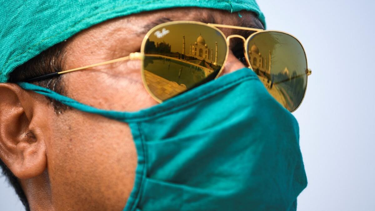 A soldier wearing a facemask as a preventive measure against the Covid-19 coronavirus stands guard at Taj Mahal in Agra on September 21, 2020. The Taj Mahal reopened to visitors on September 21 in a symbolic business-as-usual gesture even as India looks set to overtake the US as the global leader in coronavirus infections. Sajjad HUSSAIN / AFP