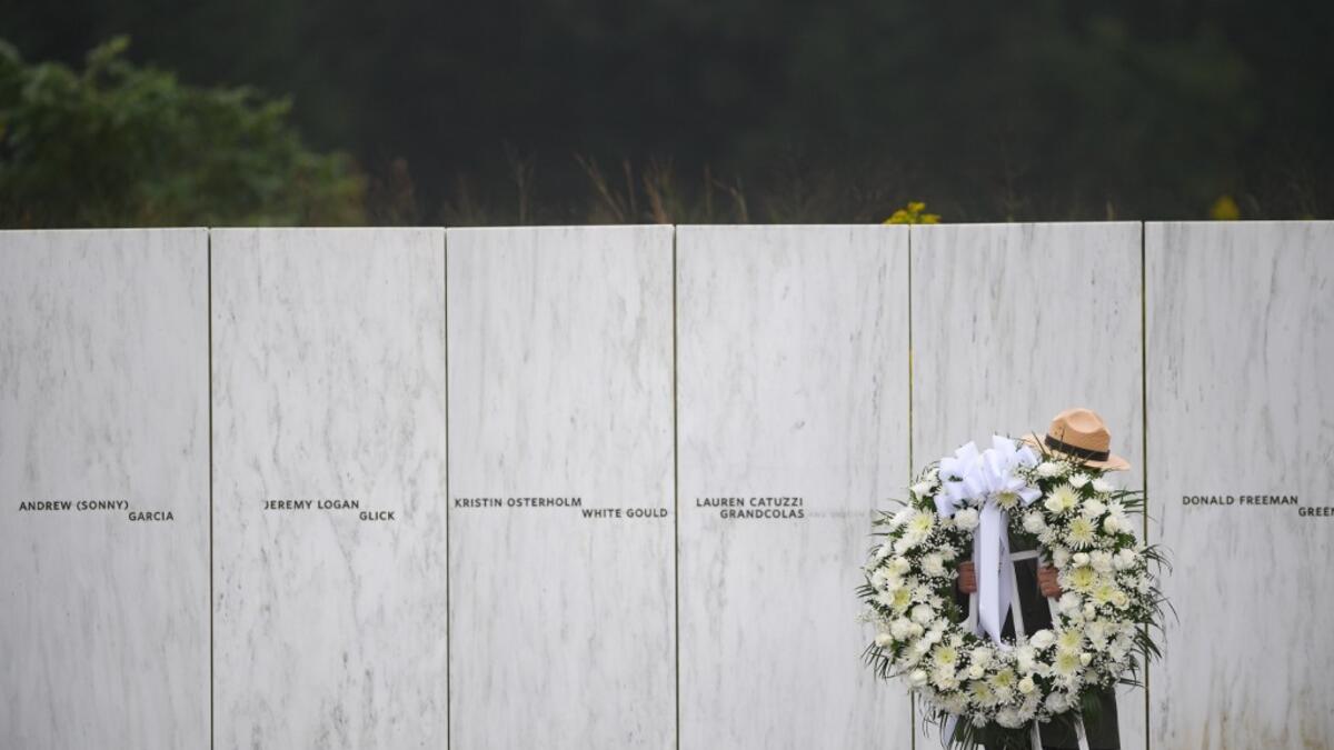 A US Park Ranger moves a memorial wreath prior to President Donald J. Trump delivering remarks at the Flight 93 National Memorial commemorating the 17th Anniversary of the crash of Flight 93 and the September 11th terrorist attacks on September 11, 2020 in Shanksville, Pennsylvania. The nation is marking the nineteenth anniversary of the terror attacks of September 11, 2001, when the terrorist group al-Qaeda flew hijacked airplanes into the World Trade Center and the Pentagon, killing nearly 3,000 people. J
