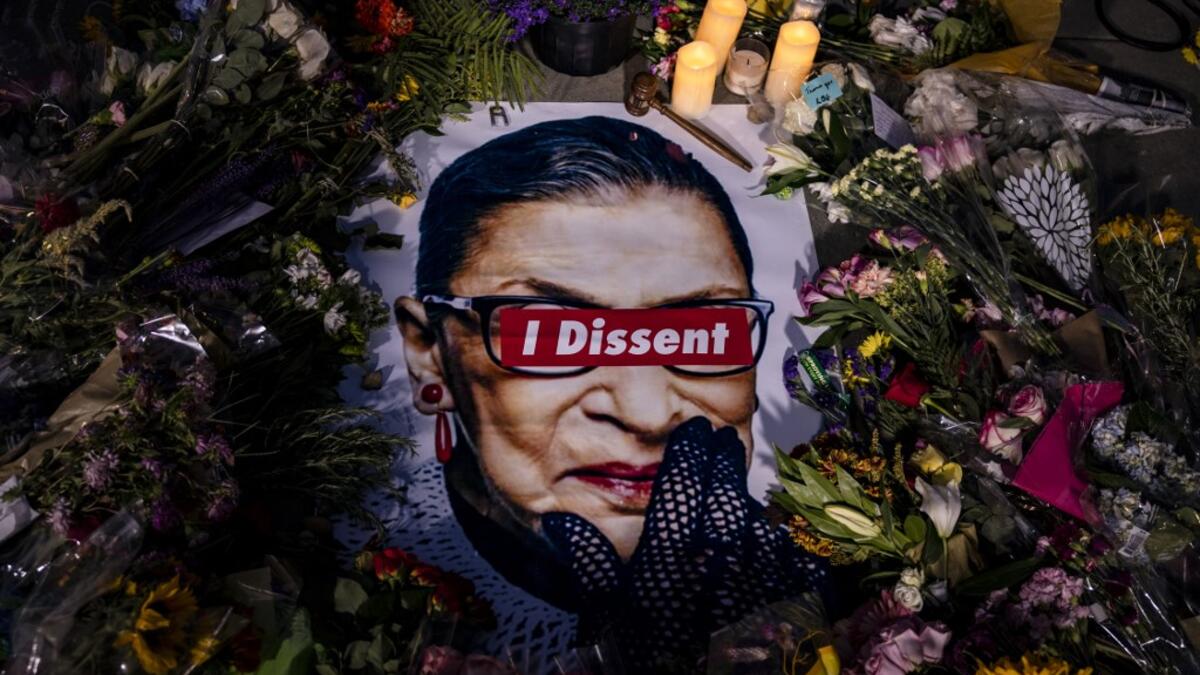 People left mementos in a makeshift memorial for Supreme Court Justice Ruth Bader Ginsburg in front of the US Supreme Court on September 19, 2020 in Washington, DC. Justice Ginsburg has died at age 87 after a battle with pancreatic cancer. Samuel Corum/Getty Images/AFP Samuel Corum / GETTY IMAGES NORTH AMERICA / Getty Images via AFP