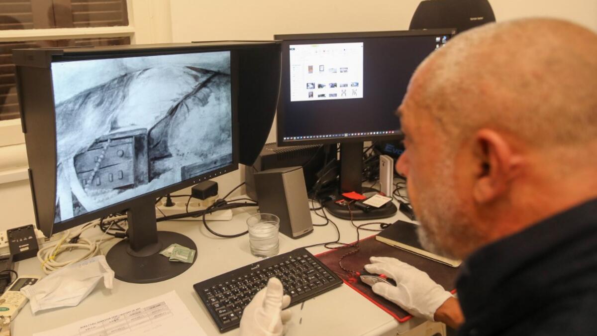Gaby Maamary, a Lebanese artwork conservation specialist, checks an image scan during an interview at his studio in the capital Beirut on September 17, 2020. The blast at the capital's port on August 4 killed more than 190 people, and wounded thousands more as it sent lethal shockwaves pummelling through the city. But it also ravaged dozens of the capital's mot cherished heritage buildings. ANWAR AMRO / AFP